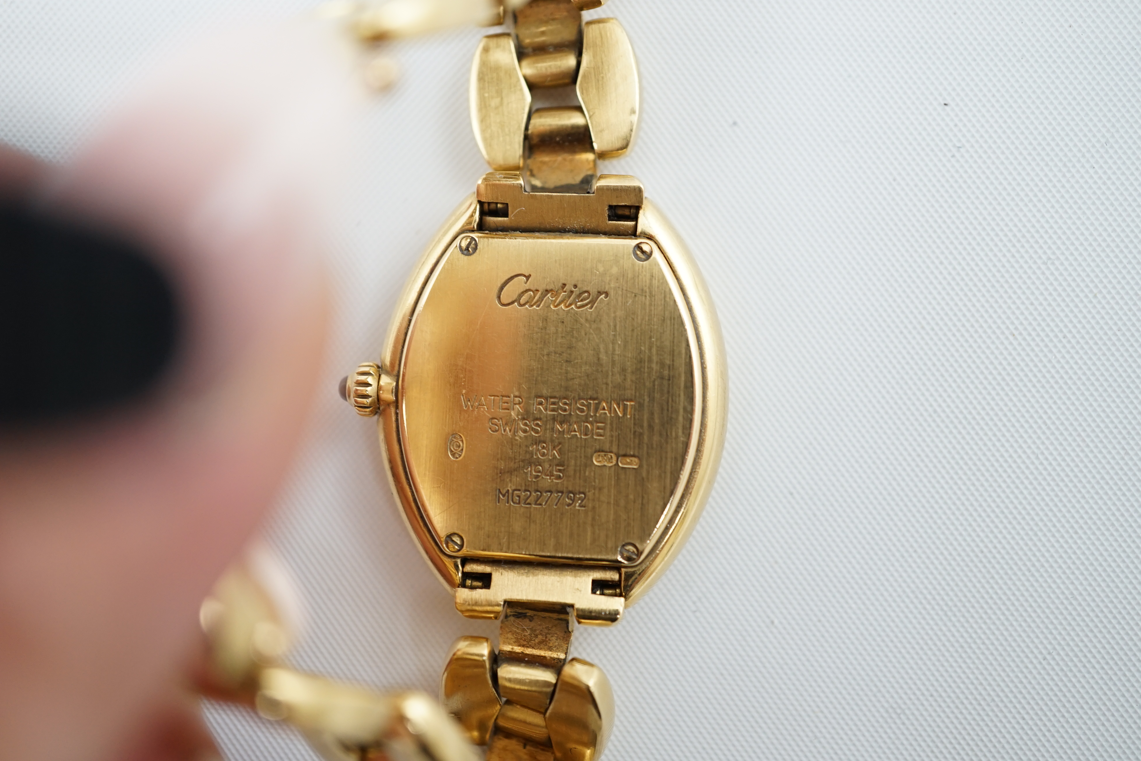 A lady's late 1990's? 18k gold Cartier quartz wrist watch, on an 18 k gold Cartier bracelet